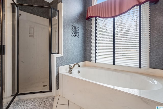 bathroom featuring shower with separate bathtub and tile patterned flooring