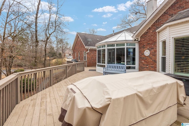 wooden deck with a sunroom