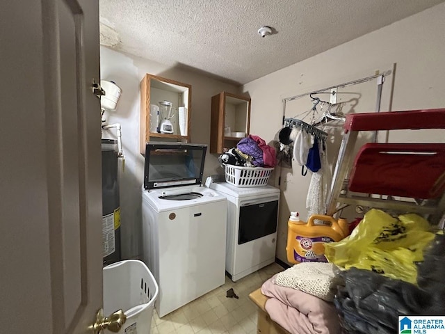 washroom with washing machine and clothes dryer and a textured ceiling