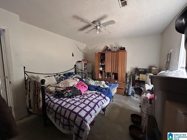 bedroom featuring ceiling fan, concrete flooring, and a textured ceiling