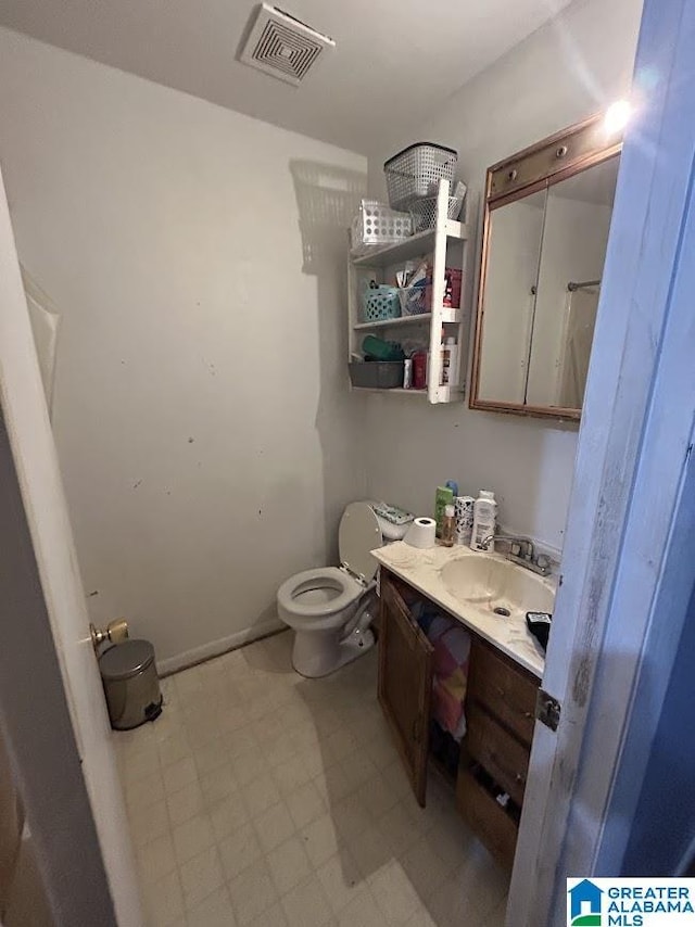 bathroom with vanity and toilet