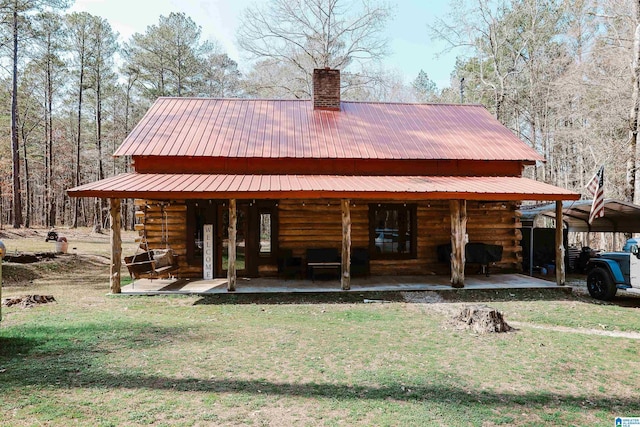 back of house featuring a lawn and a patio