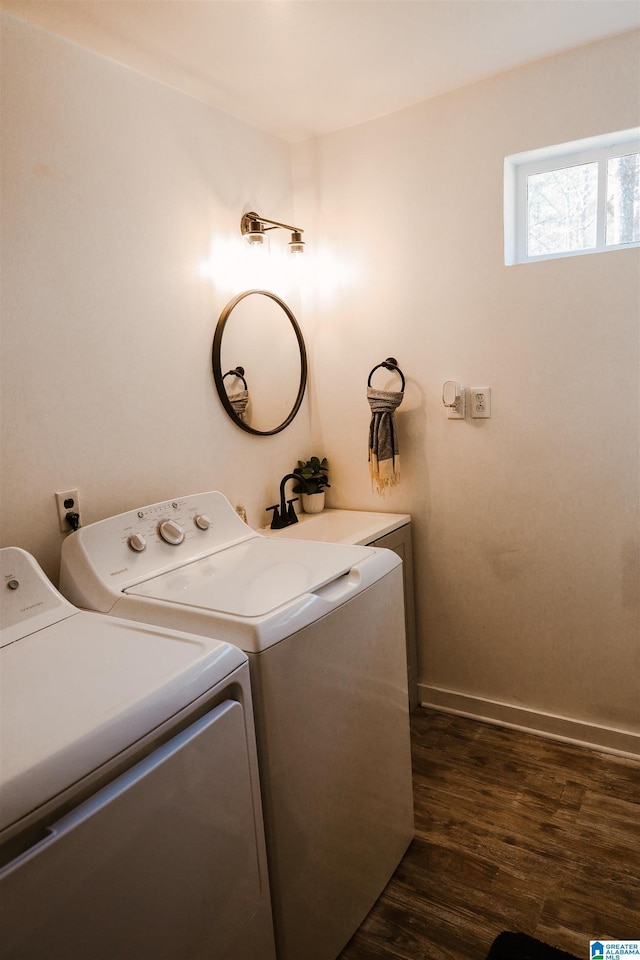 clothes washing area with dark hardwood / wood-style flooring and washing machine and dryer