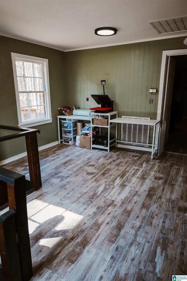 unfurnished office featuring hardwood / wood-style flooring and ornamental molding