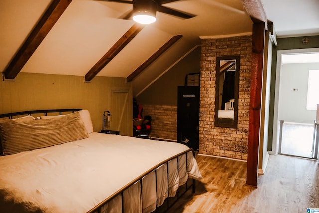 bedroom featuring brick wall, lofted ceiling with beams, and light hardwood / wood-style flooring