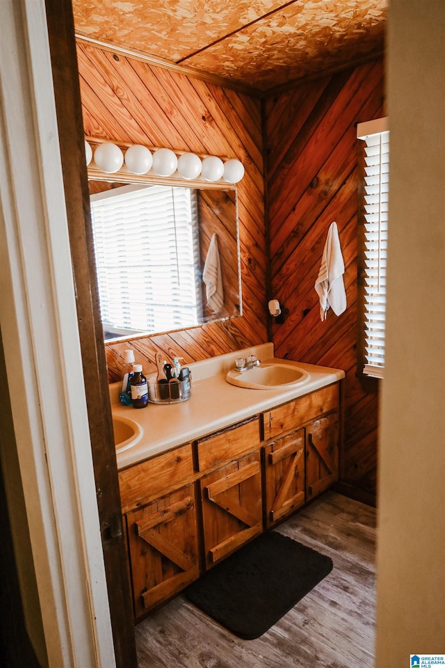 bathroom featuring vanity, wood-type flooring, and wood walls