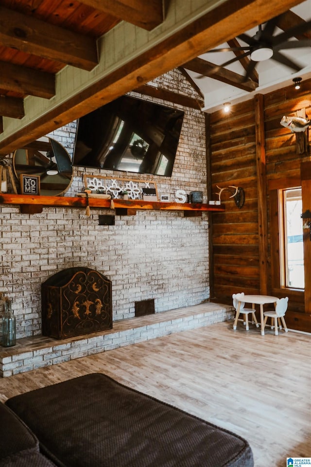 interior space featuring ceiling fan and a fireplace