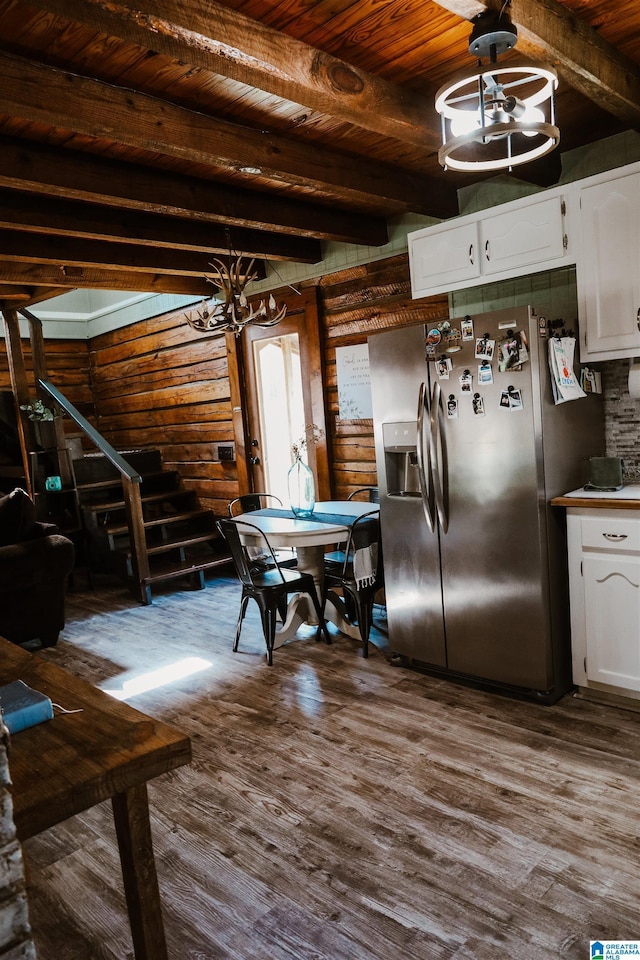 kitchen featuring hardwood / wood-style floors, stainless steel fridge, and white cabinets