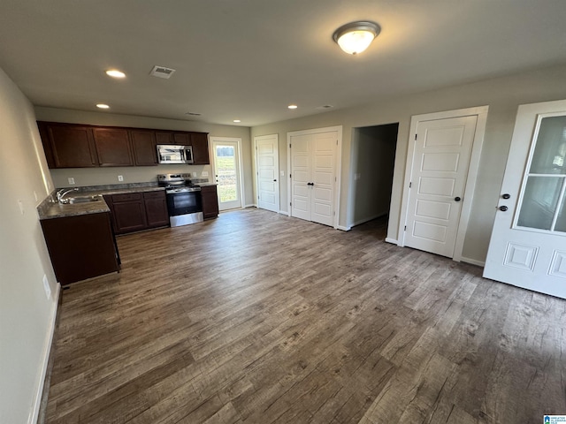 kitchen featuring dark brown cabinetry, stainless steel appliances, sink, and hardwood / wood-style floors