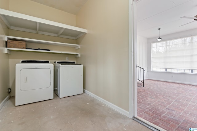 laundry area featuring brick floor, laundry area, a ceiling fan, baseboards, and washer and clothes dryer