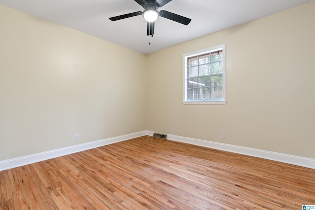 spare room featuring a ceiling fan, baseboards, visible vents, and light wood finished floors