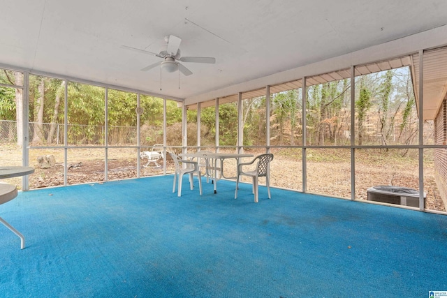 unfurnished sunroom with ceiling fan