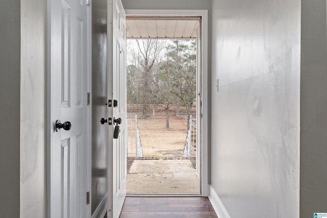 entryway with wood finished floors and baseboards