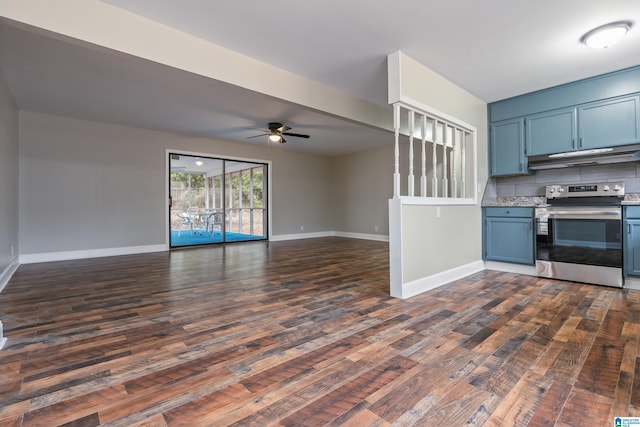 kitchen with electric stove, blue cabinetry, light countertops, open floor plan, and under cabinet range hood