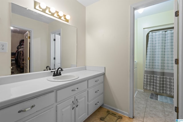 bathroom with tile patterned flooring, vanity, and curtained shower