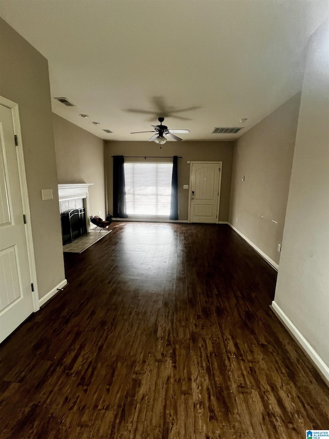 unfurnished living room with dark wood-type flooring and ceiling fan