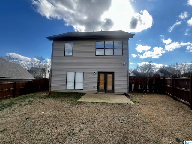 rear view of property featuring french doors, a yard, and a patio area