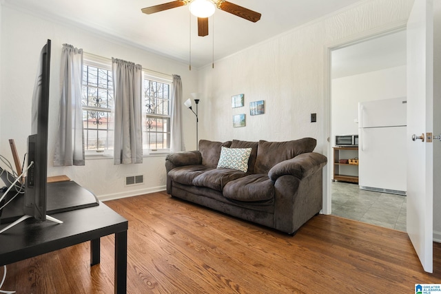 living room featuring hardwood / wood-style flooring and ceiling fan