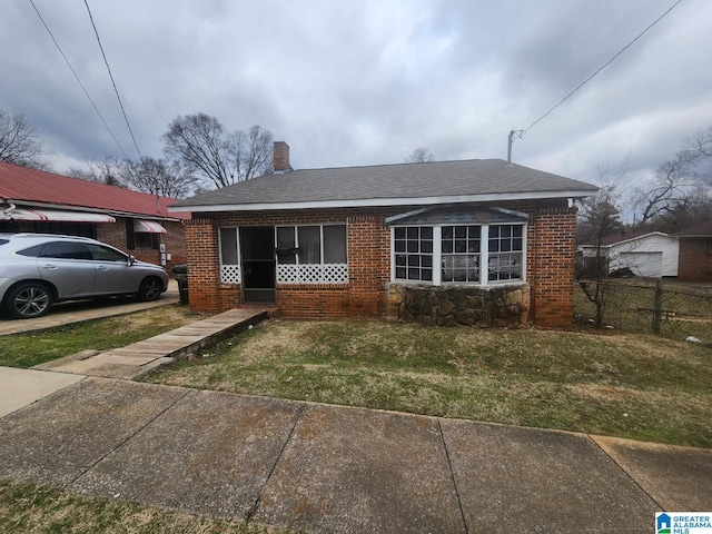 bungalow-style home with a front lawn