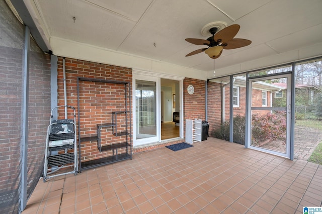 unfurnished sunroom with ceiling fan and a healthy amount of sunlight