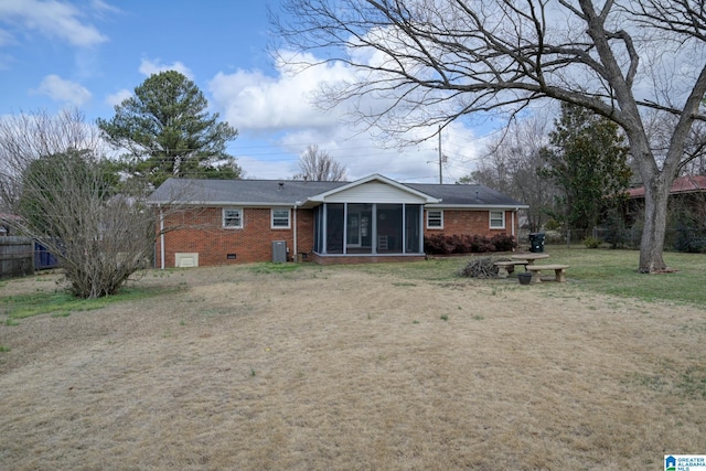 back of property featuring a yard and a sunroom