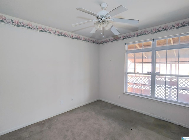 unfurnished room with ceiling fan and carpet flooring