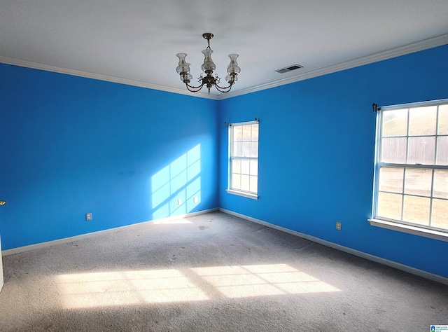 unfurnished room with crown molding, carpet floors, and an inviting chandelier