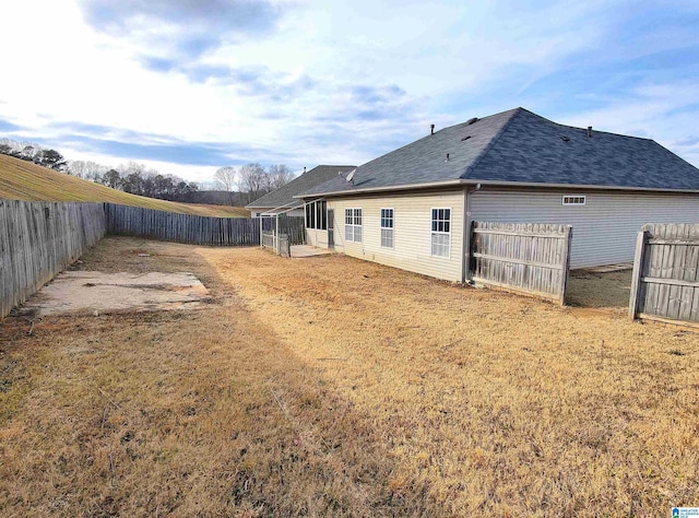 rear view of house featuring a lawn