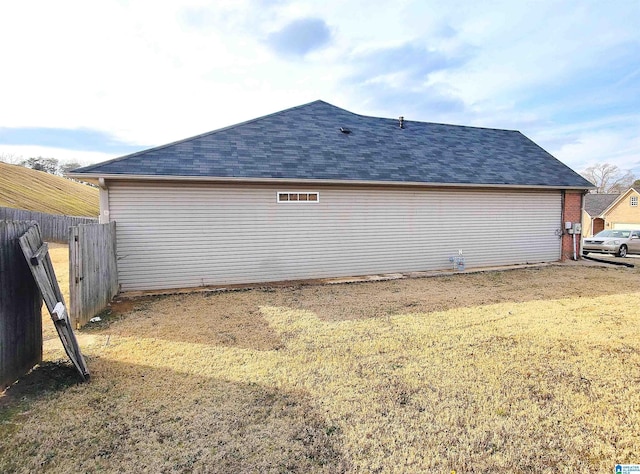 view of side of home featuring a lawn