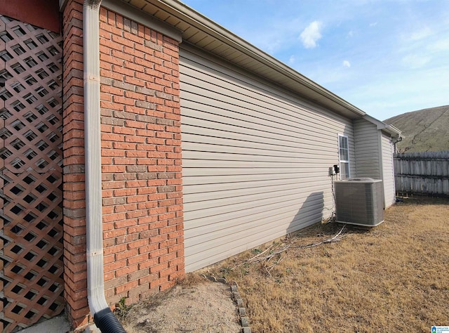 view of side of home with central AC