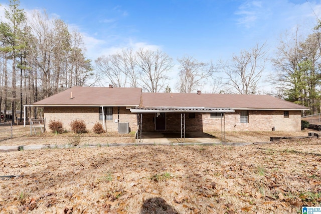 rear view of property featuring central AC and a patio area