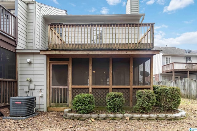 back of house featuring a balcony, central AC unit, and a sunroom