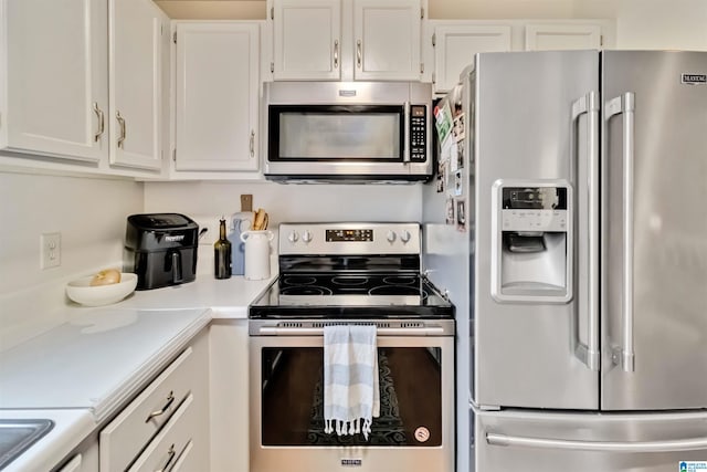 kitchen with stainless steel appliances and white cabinets