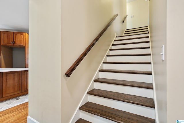 staircase with hardwood / wood-style floors