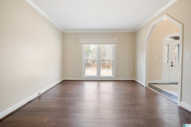 spare room with crown molding and dark hardwood / wood-style flooring