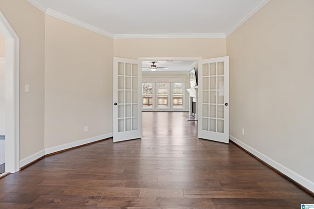 spare room featuring dark hardwood / wood-style flooring, ornamental molding, french doors, and ceiling fan