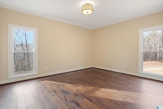 spare room with ornamental molding and dark wood-type flooring