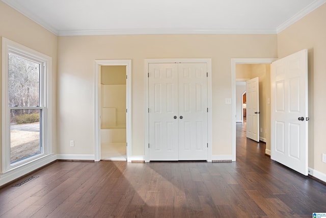 unfurnished bedroom featuring crown molding, dark hardwood / wood-style floors, and multiple windows