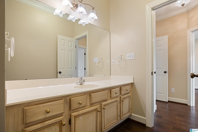 bathroom featuring hardwood / wood-style flooring, ornamental molding, and vanity