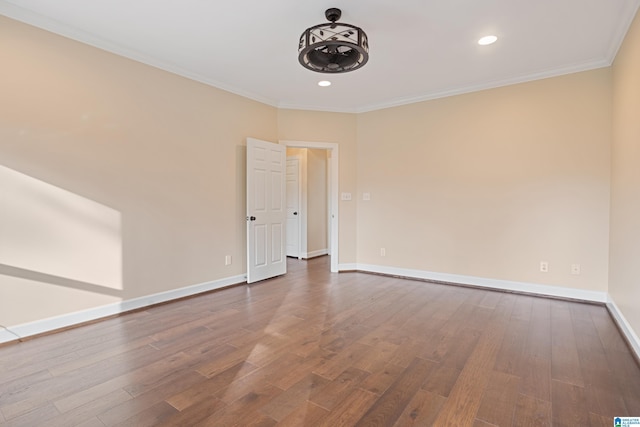 unfurnished room with ornamental molding and hardwood / wood-style floors