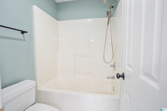 bathroom with bathing tub / shower combination and toilet