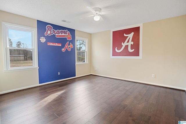 empty room with hardwood / wood-style floors, a textured ceiling, and ceiling fan