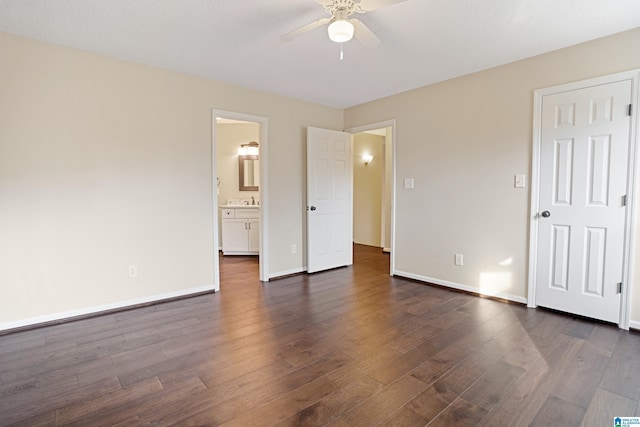 unfurnished bedroom featuring ceiling fan, connected bathroom, and dark hardwood / wood-style flooring