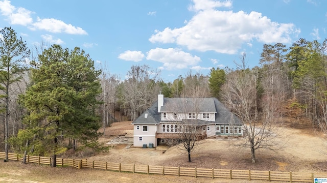 back of house with a rural view