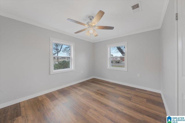 unfurnished room with ornamental molding, dark wood-type flooring, and a wealth of natural light