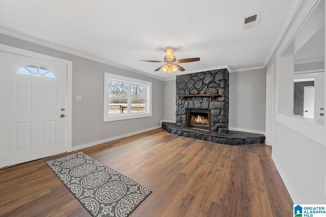 living room featuring hardwood / wood-style flooring, ceiling fan, a fireplace, and crown molding