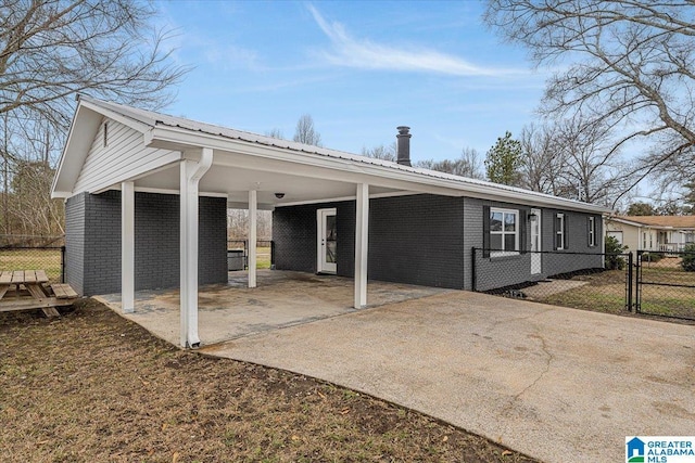 view of side of home with a carport