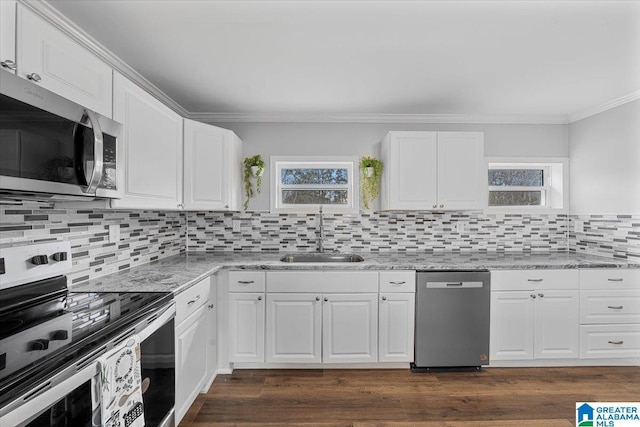 kitchen featuring light stone counters, sink, white cabinets, and appliances with stainless steel finishes