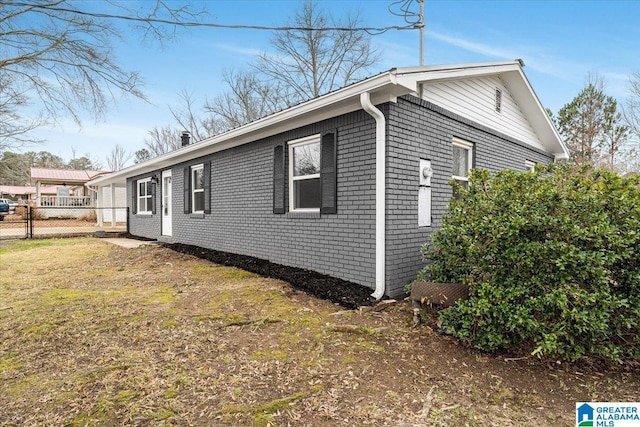 view of property exterior with a lawn