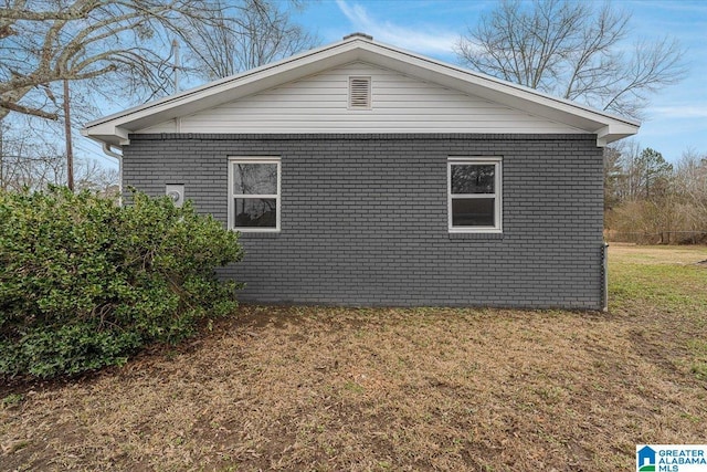 view of side of home featuring a lawn